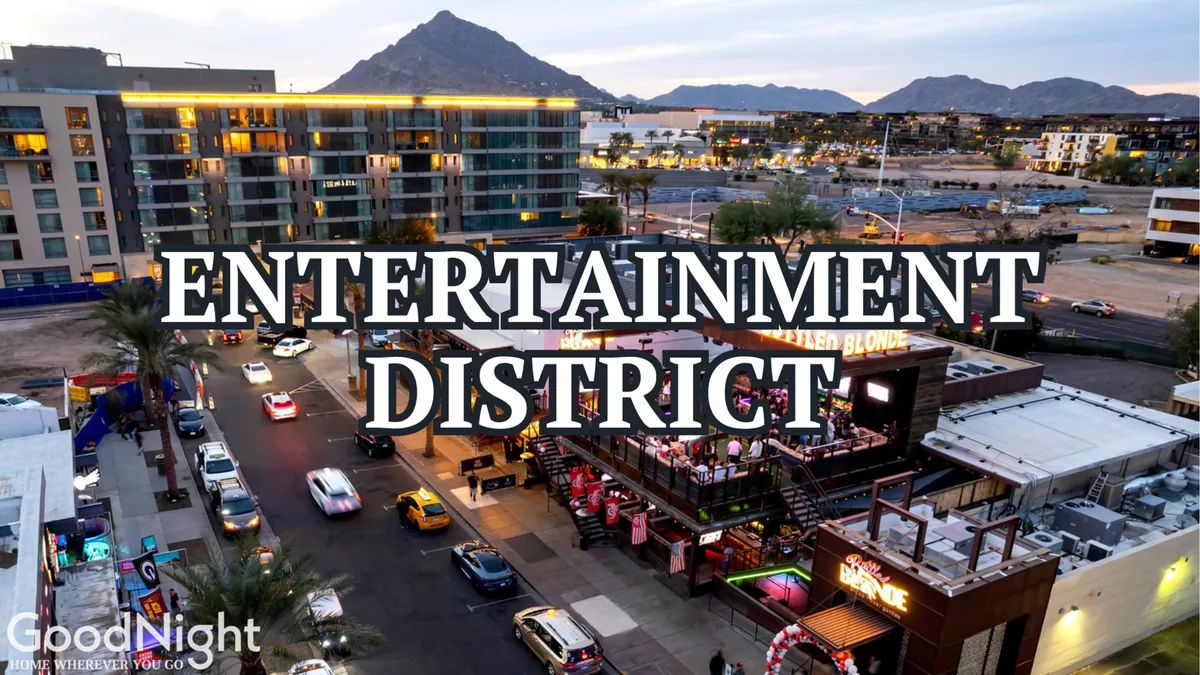 A vibrant scene from Scottsdale’s Entertainment District, featuring bold signage, lively outdoor dining areas, and bustling streets. The area is illuminated with energy, evoking the city’s renowned nightlife and social scene.