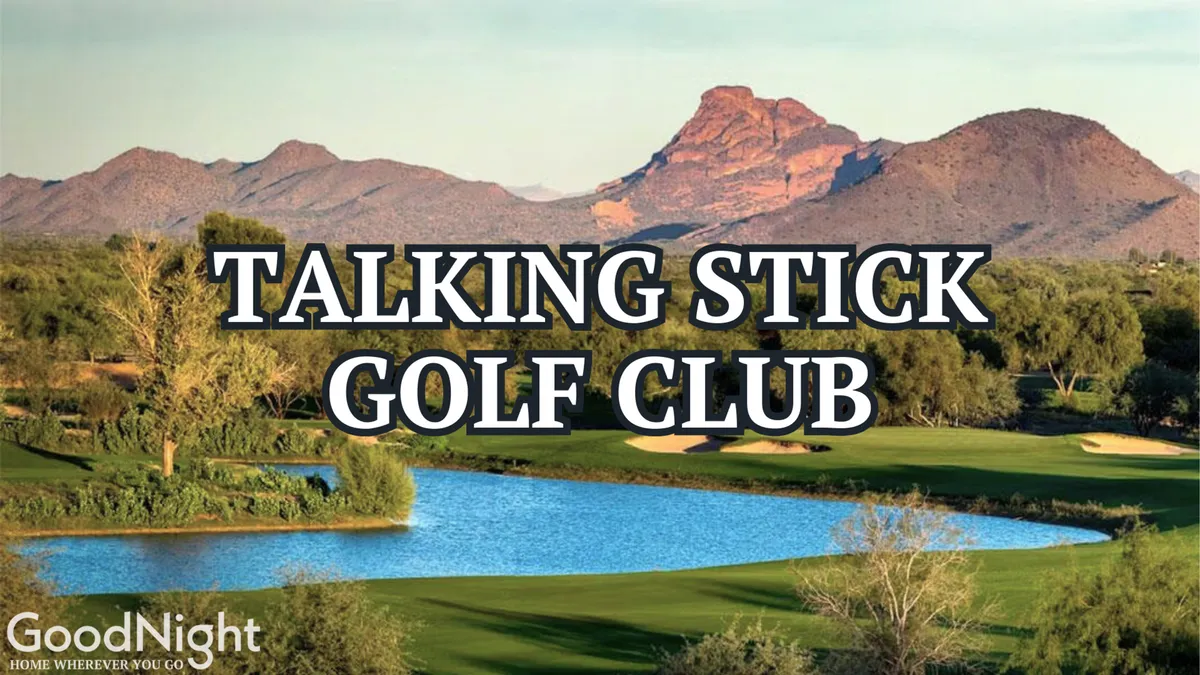This image captures a lush golf course bordered by a shimmering water feature and framed by majestic mountains in the background. The expansive greenery offers a tranquil setting, perfect for highlighting the area's world-class golf experiences.